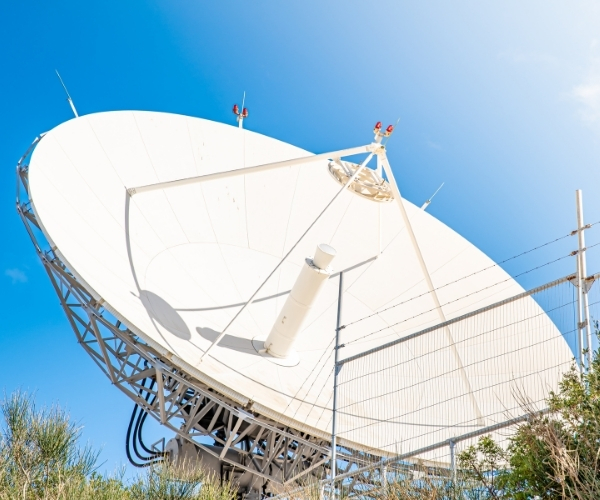 A large satellite dish positioned on a hill