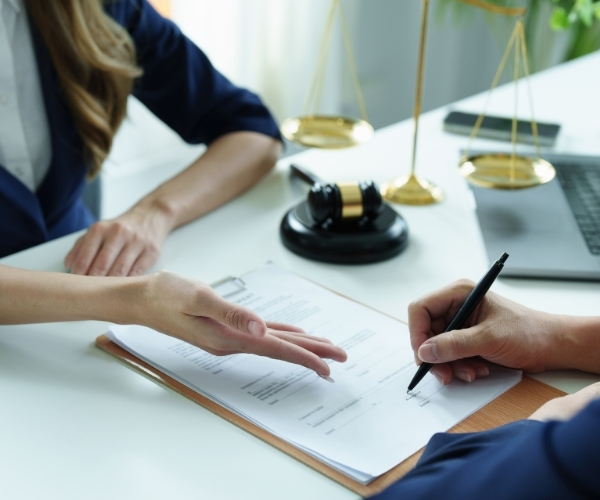 A lawyer and a client are seated at a table
