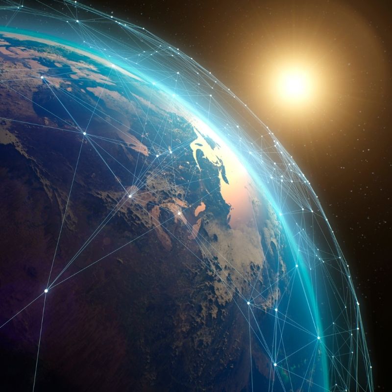 Earth surrounded by network lines with the sun shining in space
